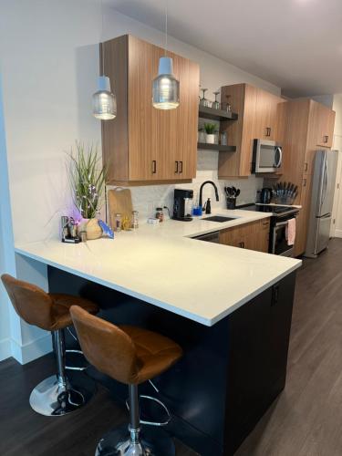 a kitchen with a white counter top and wooden cabinets at central located Modern west Midtown suite in Atlanta