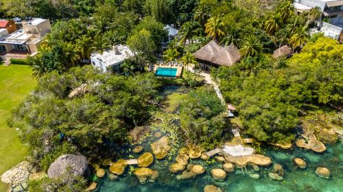 an aerial view of a backyard with a resort at Azulea Bacalar Hotel & Spa - Lagoon Front in Bacalar