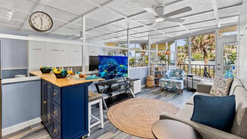 a kitchen and living room with a clock on the ceiling at Ocean Oasis - Ocean View At Symphony Beach Club in Ormond Beach