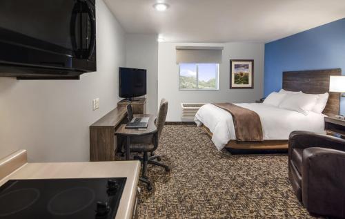 a hotel room with a bed and a flat screen tv at My Place Hotel-Green Bay, WI in Green Bay