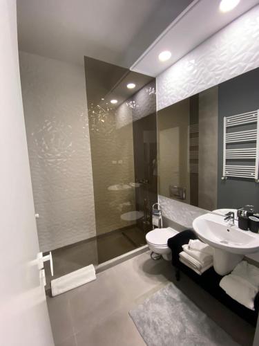 a bathroom with a sink and a toilet and a shower at LY Studio Pipera in Voluntari