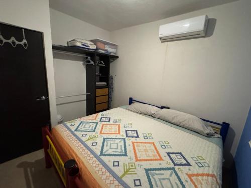 a bedroom with a bed with a quilt on it at Casa Mar y Laguna PUERTA AL SOL in General Juan N Alvarez International Airport
