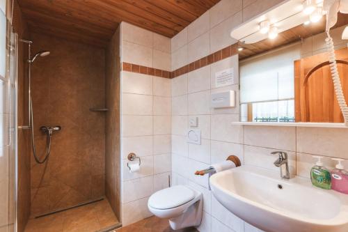 a bathroom with a toilet and a sink and a shower at Garni Hotel Berc in Bled
