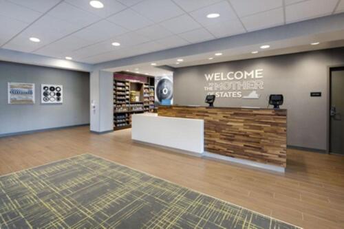 a lobby with a welcome sign in a store at Hampton Inn & Suites Richmond Short Pump, Va in Richmond