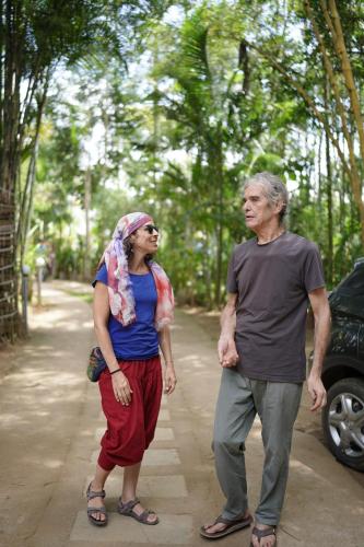 a man and a woman walking down a road at Ananda Holiday Home in Ambalavayal