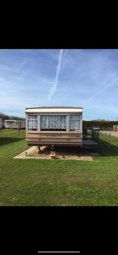 a bus parked in a field in a park at Summerlands caravan park, p29 in Skegness