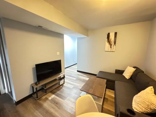 a living room with a couch and a flat screen tv at COZY 2BR Apartment near Downtown DC in Washington, D.C.
