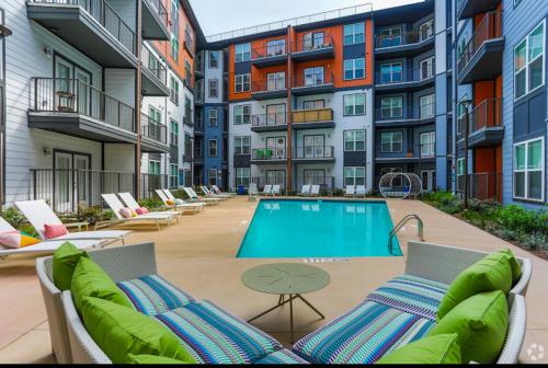 an apartment patio with a swimming pool in front of buildings at Central Buckhead Suite in Atlanta