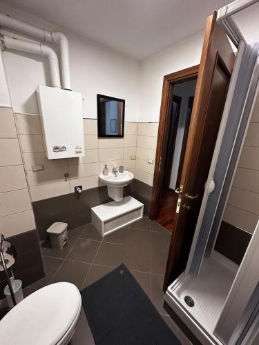 a bathroom with a white toilet and a sink at Casa Camelia in Zagarolo
