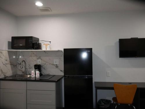 a kitchen with a black refrigerator and a counter at Studio 6 Tacoma, WA - South in Tacoma