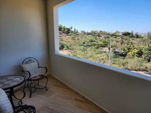a room with a large window and two chairs at Casa Vista Animas San Jose del Cabo in San José del Cabo