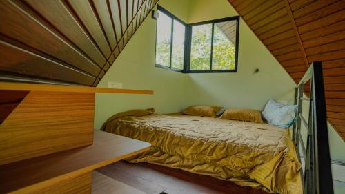 a bedroom with a bed in the corner of a room at Private Hut in Thusharagiri in Vallikavungal