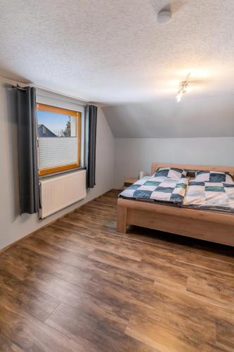 Postel nebo postele na pokoji v ubytování Ferienwohnung Eifelhöhe Pützer