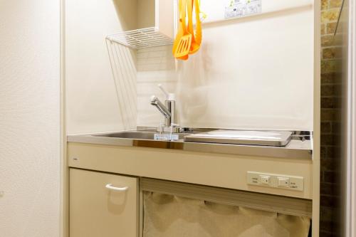 a kitchen with a sink and a counter top at Y's INN NishiShinjuku 018T in Tokyo