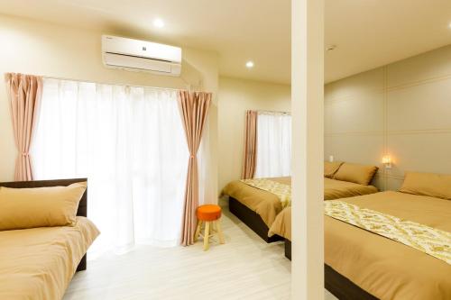 a hotel room with two beds and a window at Y's INN NishiShinjuku 018T in Tokyo