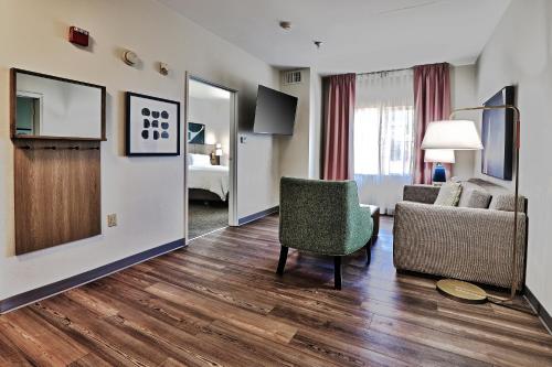 a living room with a couch and a chair at Staybridge Suites - Albuquerque Airport by IHG in Albuquerque