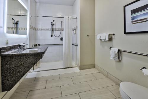 a bathroom with a shower and a sink at Staybridge Suites - Albuquerque Airport by IHG in Albuquerque