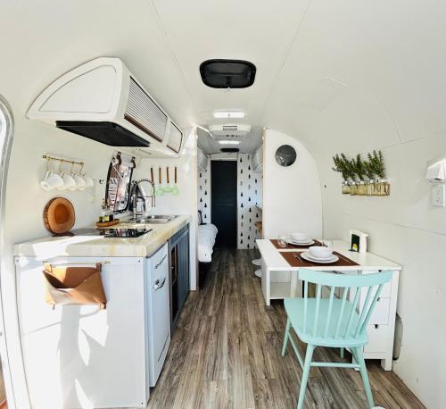 a kitchen and dining area of an rv at Stay in Style - Airstream & Views in Spring Valley
