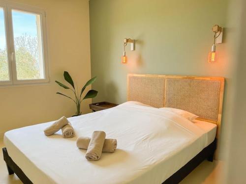 une chambre avec un grand lit avec des serviettes dessus dans l'établissement Grande Villa avec Piscine, Pétanque et Vue Mer pour 12 Personnes, au Beausset