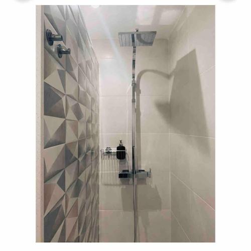 a shower with a glass door in a bathroom at CAPISTRANO BREEZE - Luxury Coastal Apartment in Capistrano Village, Nerja in Nerja