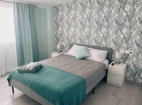 a bedroom with a bed with a bird wallpaper at CAPISTRANO BREEZE - Luxury Coastal Apartment in Capistrano Village, Nerja in Nerja