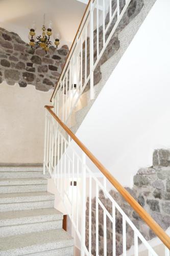 a staircase in a house with a stone wall at Gardar in Bolzano