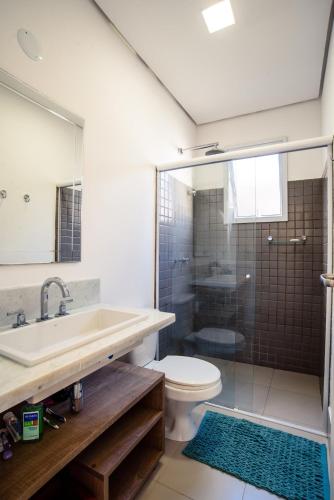 a bathroom with a sink and a toilet and a shower at Linda Casa de alto padrão em praia de Juquehy in São Sebastião