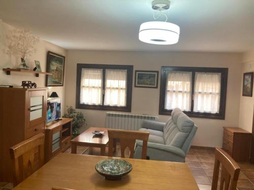 a living room with a couch and a table at Apartamento O'royo in Alquézar