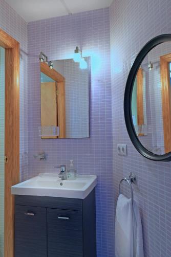 a bathroom with a sink and a mirror at Agusti Hostal in Sant Carles de la Ràpita