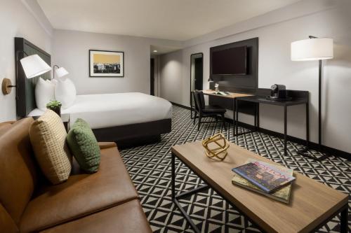 a hotel room with a bed and a desk at The Arcadian in Brookline
