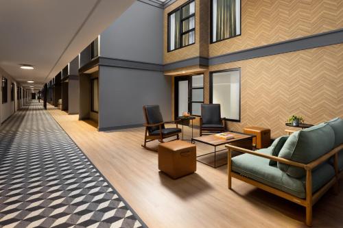 an office lobby with a couch and chairs at The Arcadian in Brookline