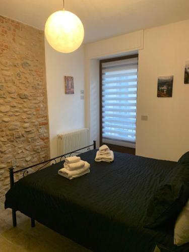 a bedroom with a bed with towels on it at Il Sogno di GioEle in Borgo San Dalmazzo