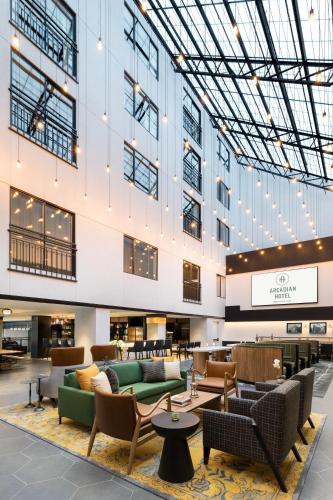a lobby with couches and chairs in a building at The Arcadian in Brookline