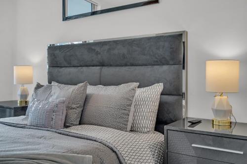 a bedroom with a large bed with pillows and lamps at icon Brickell 2 bed 2bath at W residence in Miami