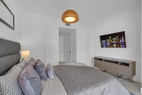 a bedroom with a bed and a television on the wall at icon Brickell 2 bed 2bath at W residence in Miami