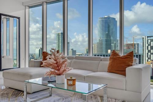 a living room with a white couch and a glass table at icon Brickell 2 bed 2bath at W residence in Miami