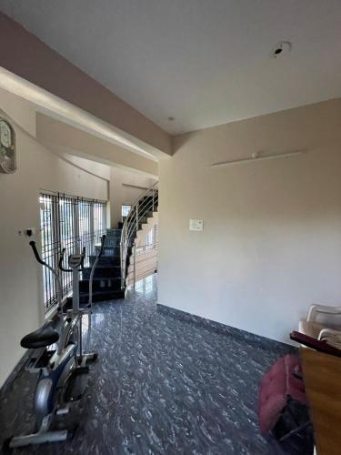 a gym with cardio equipment in a room at Deqorum villas in Kumbakonam
