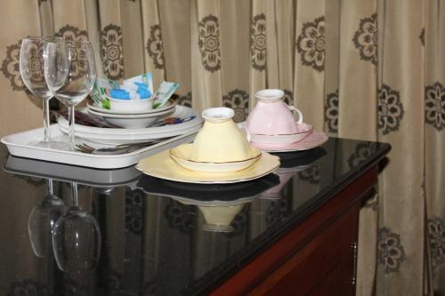 a table with plates and wine glasses on it at Hotel Sergul in London