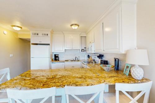 a kitchen with a large marble counter top at Breakers 215 in Hilton Head Island