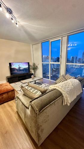a bedroom with a large bed and a large window at Luxury apartment in the city center in Rotterdam