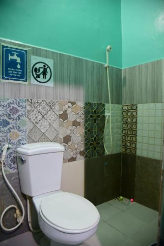 a bathroom with a toilet and a shower at Wind Stay in Male City