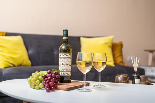a bottle of wine and two glasses on a table at Cozy studio in the centre in Sitia