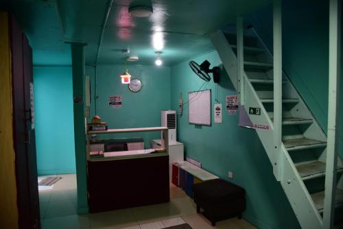 a room with a bunk bed and a staircase at Wind Stay in Male City