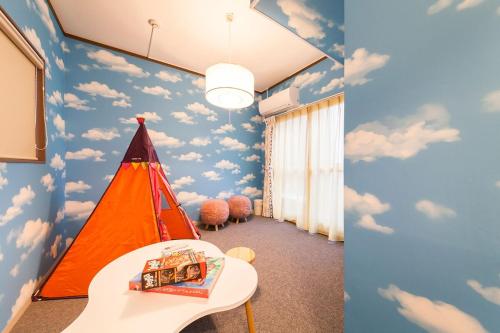 a childs room with clouds painted on the walls at 楽宿 Itabashi 011T in Tokyo