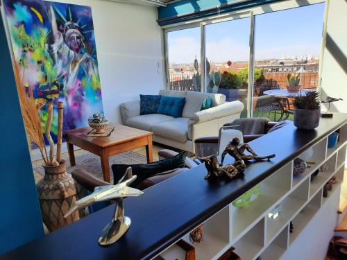 a living room with a couch and a table at 360 degrés sur la rochelle chambre d hôte in La Rochelle