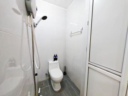 a white bathroom with a toilet and a shower at 45GeorgeTown Multi Family corner lot free parking food convenience stores nearby in George Town