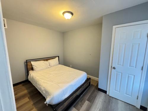 a small bedroom with a bed and a door at NICE 2-Bedroom Apartment in DC in Washington, D.C.