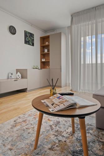 a living room with a coffee table and a couch at The Address Bucharest in Bucharest