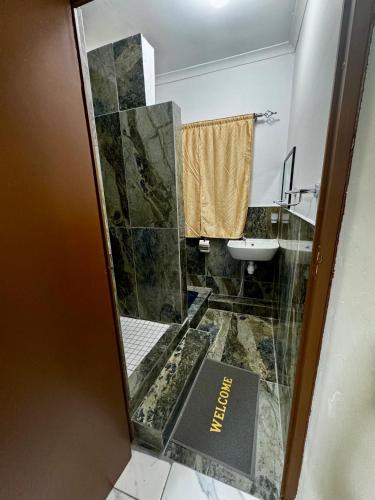 a bathroom with a sink and a toilet and a mirror at Kitty Guest House in Bellville