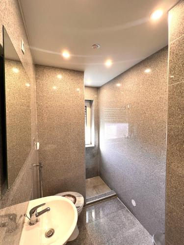 a bathroom with a sink and a shower at Gästehaus Schwabach in Schwabach